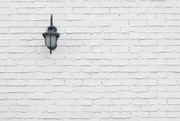 The lamp is mounted on the white wall, mortar concrete, cement texture