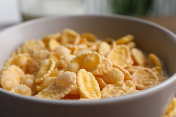 Tasty cornflakes with milk in bowl, closeup