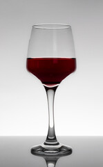 A glass of red wine on a white background.