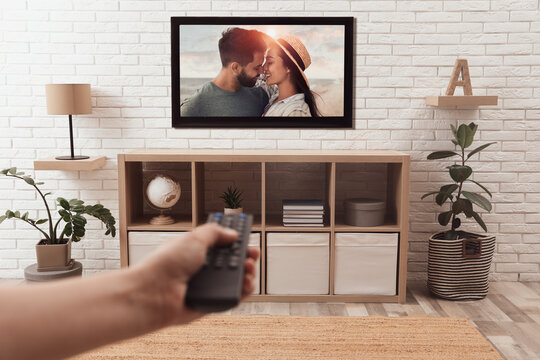 Man watching romantic movie on TV at home