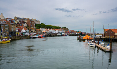 Fototapeta premium A view of Whitby harbour looking towards the harbour entrance from the swing bridge