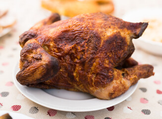 ruddy chicken fried whole on a plate on the festive table