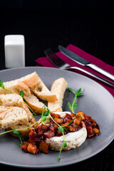 French camembert cheese baked in the oven served with croutons