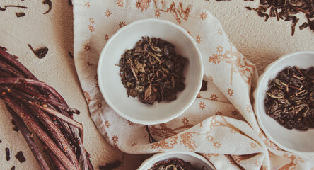 Small bowls with dried healing green tea and herbs, ritual purification and cleansing, closeup