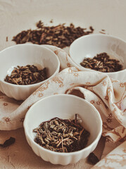 Fototapeta na wymiar Small bowls with dried healing green tea and herbs, ritual purification and cleansing, closeup
