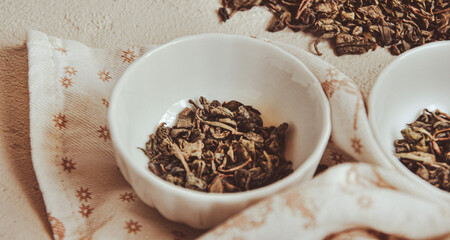 Small bowls with dried healing green tea and herbs, ritual purification and cleansing, closeup