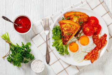 irish breakfast of fried eggs, bacon, potato farls