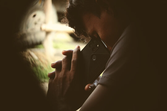 An Indian Or Asian Young Sad Farmer Feeling Depressed After Receiving A Phone Call On His Smartphone. Copy Space.