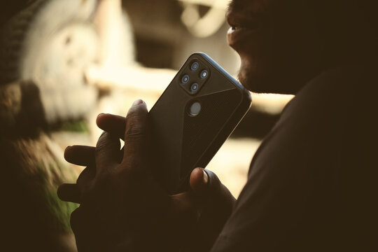 An Indian Or Asian Young Sad Farmer Feeling Relaxed After Receiving A Phone Call On His Smartphone. Copy Space.