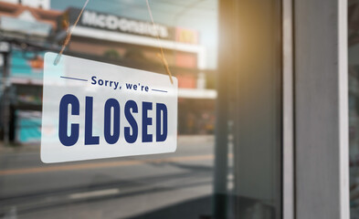 Sign text hangs on the entrance door of the shop, restaurant, cafe. That reads 