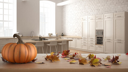 Autumn pumpkins still life on wooden table. Thanksgiving Halloween decoration over interior design scene. Modern kitchen in classic apartment with brick wall