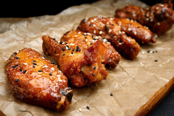 Grill chicken legs and wings on craft paper
