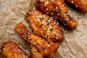 Grill chicken legs and wings on craft paper