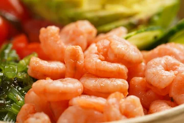 Fotobehang Boeddha Trendy wholesome dish poke or buddha bowl - rice, wakame seaweed, tomatoes, cucumber, and red fish salmon - a close-up of cooked shrimp  © Romana