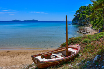 Traditional wooden fishing boat at Chrisi Milia beach in Alonissos island, Greece