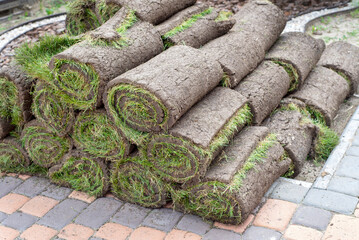 stacks of sod rolls for new lawn