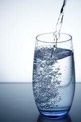 photo pouring water into a glass