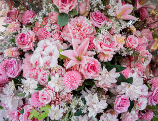 Big bouquet of flowers in a vase on a gray wall background