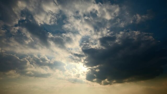 Typhoon day in summer. Fast moving dark clouds and sun beams in blue sky. 4K sky clouds time lapse.