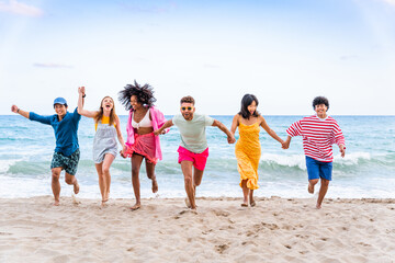 Group of young best friends bonding outdoors - Multiracial people bonding and having fun at the...