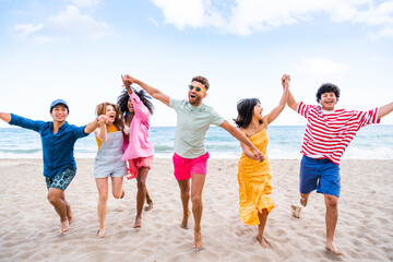 Group of young best friends bonding outdoors - Multiracial people bonding and having fun at the beach during summer vacation