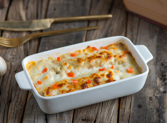 chicken cannelloni pasta served in a dish isolated on wooden background side view of pasta