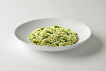 Risotto with green asparagus in white bowl