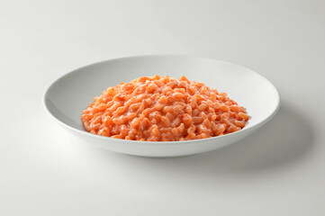 Tomato risotto in white elegant bowl