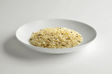 White bowl with black truffle risotto