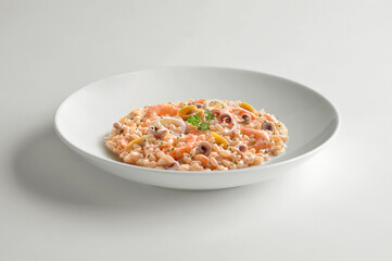 White bowl with fish risotto and parsley