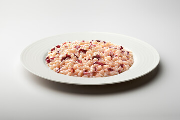Fototapeta na wymiar White dinner plate with Treviso red radicchio risotto