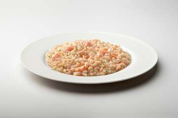 Fototapeta na wymiar White plate of risotto with shrimp and parsley