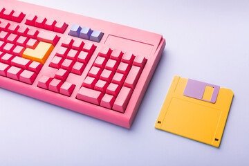 Floppy disks and keyboard on bright colored backgrounds.