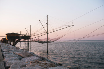 Traditional fishing house at sunrise, Dam of Sottomarina, Chioggia, Italy.