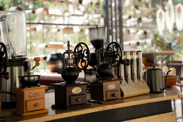 Old coffee grinder and coffee on cafe background