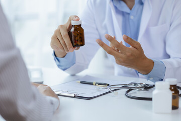 Doctors are giving advice on medication to patients in hospital examination rooms, treating diseases from specialists and providing targeted treatment. Concepts of medical treatment and specialists.