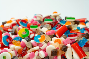 Tasty mix of jelly colorful candies isolated on a white background.