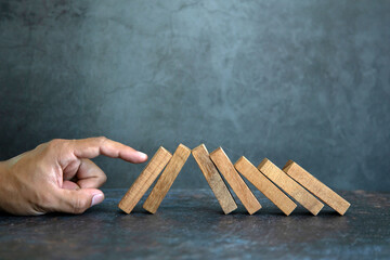 Hand prevent wooden block stacked concept of prevent collapse or crash of financial business and...