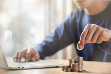 Man hands putting coins stack, Concept business finance saving money and investment.