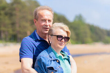 happy romantic mature adult couple family walking on beach, hugging, smiling, breathing fresh air....