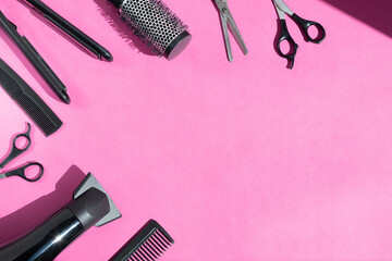 Scissors and other hairdresser's accessories on pink background, flat lay. Space for text