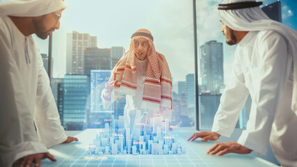 Group of Muslim Real Estate Business Developers in Traditional Clothes Discuss Investing Opportunities Based on Holographic Augmented Reality 3D City Model in Their Modern Office in a Skyscraper.