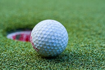 closeup shot of the golf course on a green lawn with a blurry background