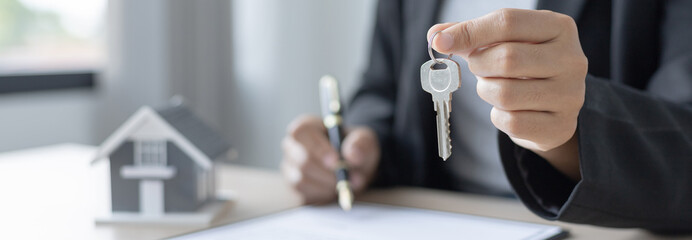 Sales manager or salesperson holds a demo house and has a home purchase contract with keys to deliver to interested customers, Sales Service, Home salesman with insurance.