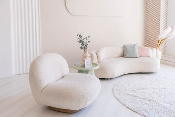Beige sofa against white wall, empty copy space in simple and modern living room interior