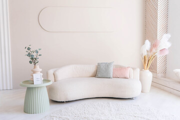 Beige sofa against white wall, empty copy space in simple and modern living room interior