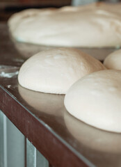 shaped bread raw dough before baking on the table in bakery