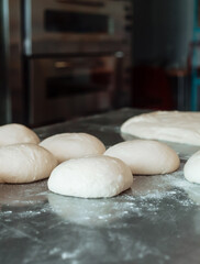 shaped bread raw dough before baking on the table in bakery