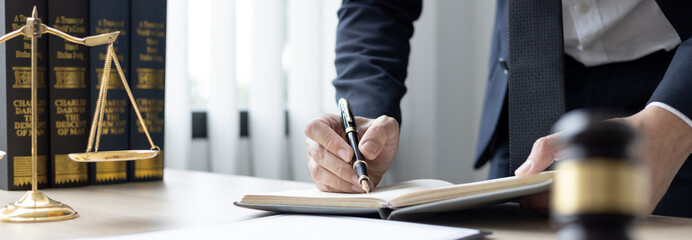 Lawyers or judges sign documents in accordance with legal and fair terms of agreement, Legal Ethics and Integrity, scales of justice, law hammer, Litigation and legal services.