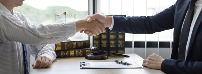 Businessman shaking hands with a lawyer or judge After signing the contract and the agreement is complete, Approval of an agreement between business and law, End of the legal case.